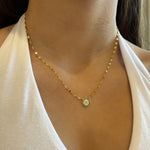 Gold evil eye necklace on model 